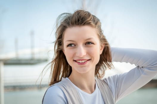 Outdoor portrait of young beautiful woman - hand in hair