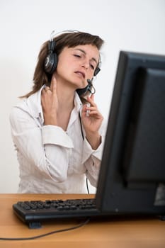 Young business person with neck pain working at computer