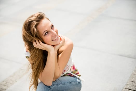 Outdoor portrait of young happy smiling beautiful woman