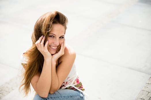 Outdoor portrait of young happy smiling beautiful woman