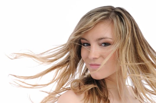 Portrait of young beautiful woman with flying hair isolated on white background