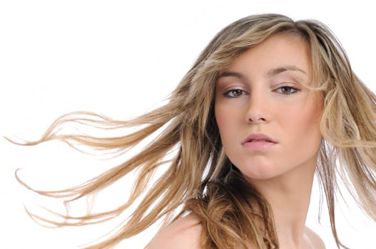 Portrait of young beautiful woman with flying hair isolated on white background