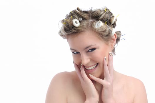 Young smiling beautiful woman with hair rollers in curls isolated on white