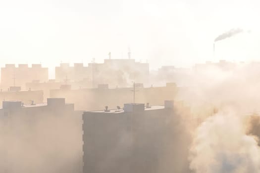 Residential area in fog and smog with chimney in background