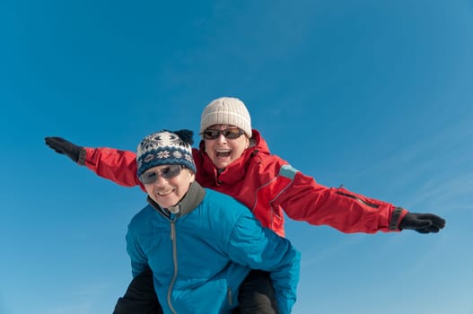 Active senior couple - smiling mature man and woman outdoor in winter