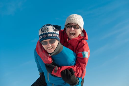 Active senior couple - smiling mature man and woman outdoor in winter