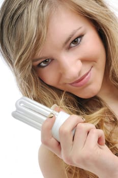 Young woman holds efficient energy saving lightbulb - isolated on white background
