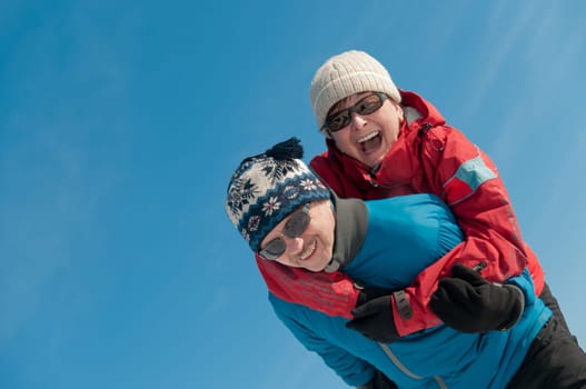 Active senior couple - smiling mature man and woman outdoor in winter