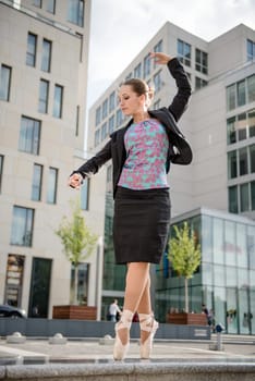 Ballet dancer dressed in business clothes dancing on street