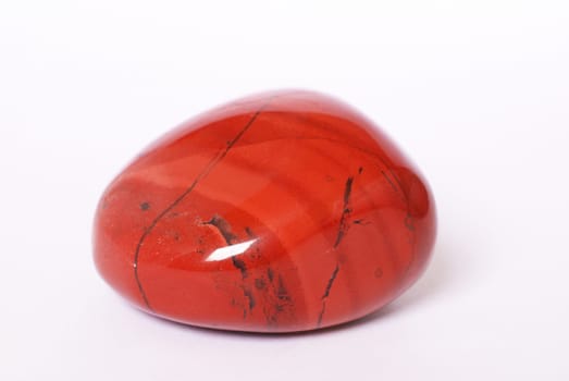 Red jasper stone on white background