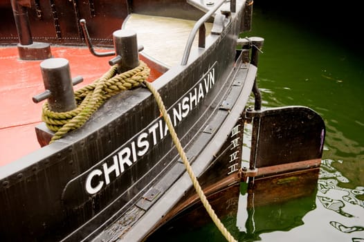 Wooden boat Christiania in canal in Copenhagen, Denmark.