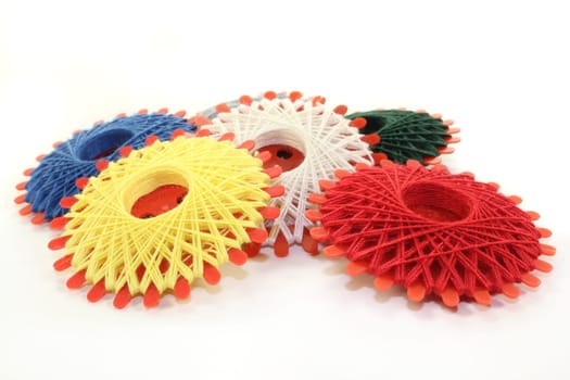 Different colored sewing thread against white background