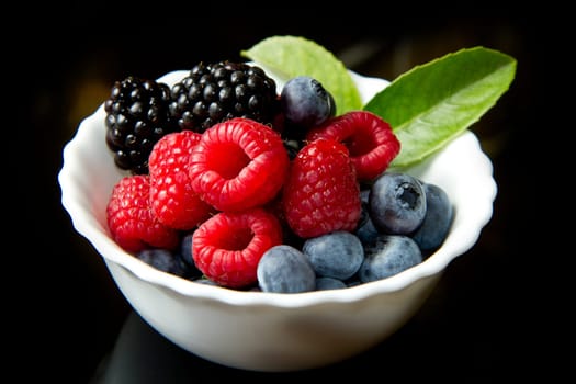 Big Pile of Fresh Berries on black background