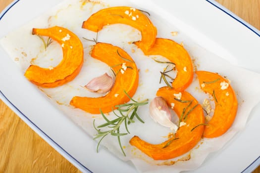 Baked pumpkin wedges with rosemary and garlic