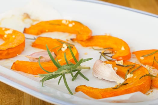 Baked pumpkin wedges with rosemary and garlic