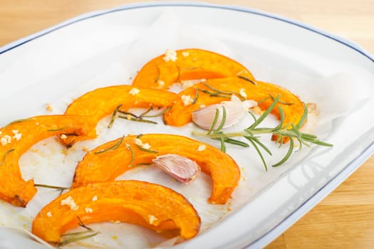 Baked pumpkin wedges with rosemary and garlic
