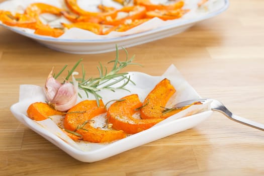 Baked pumpkin wedges with rosemary and garlic
