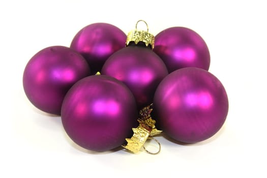 Violet Christmas baubles against white background
