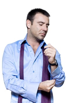 Portrait of a mature man getting dressed in studio isolated on white background