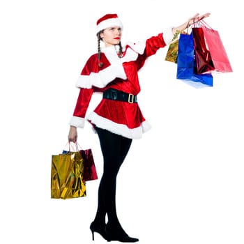 one proud woman dressed as santa claus carrying showing christmas bags  on studio isolated white background