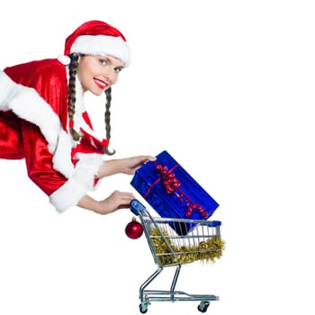 one woman dressed as santa claus holding presents gifts with christmas shopping cart on studio isolated white background