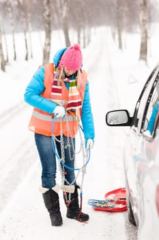 Woman holding tire chains car snow broken problems winter young