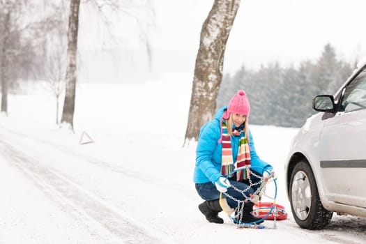 Snow tire chains winter car woman in trouble breakdown