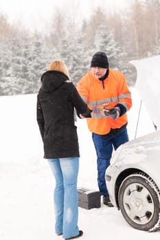 Woman handshake mechanic broken car snow help assistance winter man