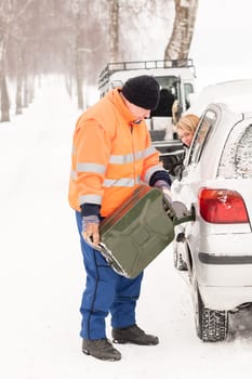 Man filling woman car gas snow assistance winter breakdown help