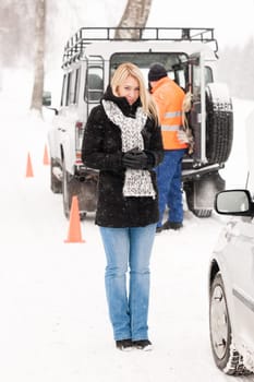 Mechanic helping woman with broken car snow assistance road winter
