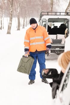 Woman broken car man gas can snow assistance winter mechanic
