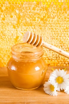 jar of honey on the background of honeycombs