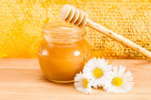 jar of honey on the background of honeycombs
