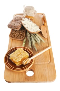 honey,  spike and bread on table, it is isolated on white