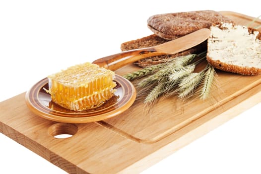 honey,  spike and bread on table, it is isolated on white