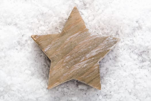 Christmas background with a closeup of a symbolic star on winter snow