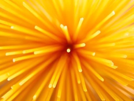 Closeup overhead view of Italian spaghetti standing upright in a container for use as an ingredient in Mediterranean cuisine