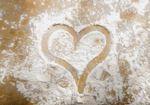 Romantic heart hand drawn in sprinkled flour from your sweetheart on Valentines day or on your anniversary