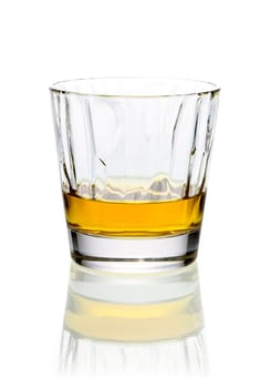 Refreshing relaxing glass of whiskey or brandy in a tumbler on a white background with reflection