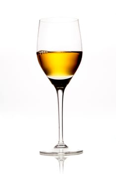 Elegant wineglass full of amber coloured wine or sherry on a white background with reflecton