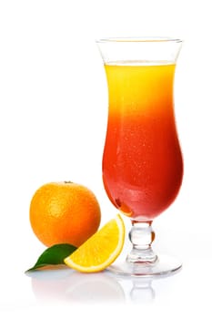 Exotic orange and rum cocktail in a tail glass with a whole and sliced fresh orange for decoration
