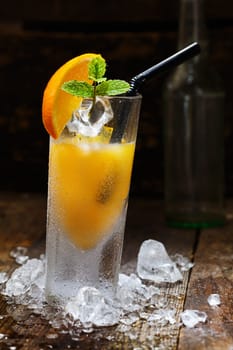 Cool Orange Alcohol Drink with crushed Ice on wooden table for drink concepts
