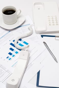 Busy office desk telephone on paper charts business meeting