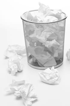 Office silver trash bin full of paper waste white isolated