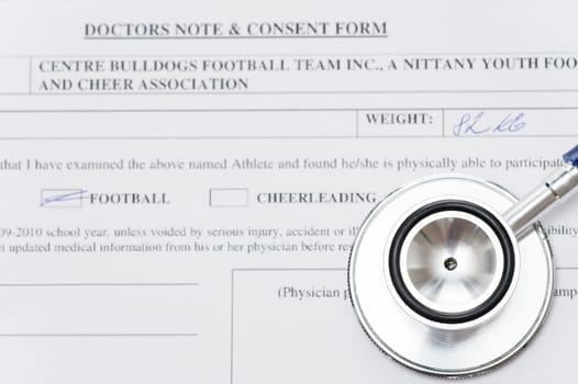 Stethoscope laying on medical chart form close-up