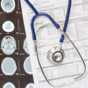 Medical report and stethoscope lying over xray doctor documentation