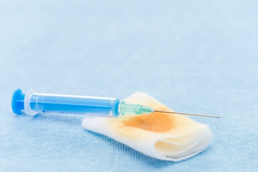 Waste after a flu shot on blue background