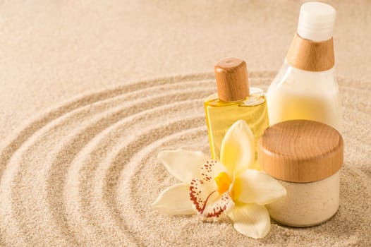 Spa body product on sand orchid flower beauty treatment