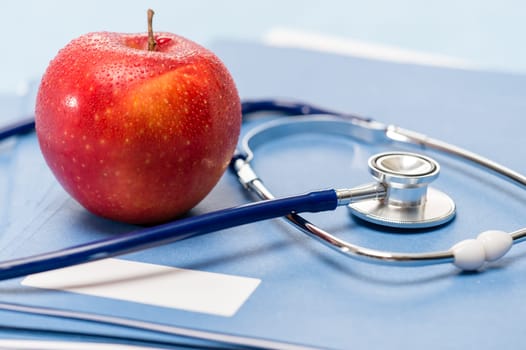 Healthcare red apple and medical stethoscope healthy lifestyle