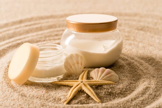 Spa body cream seashell star on sand beauty treatment